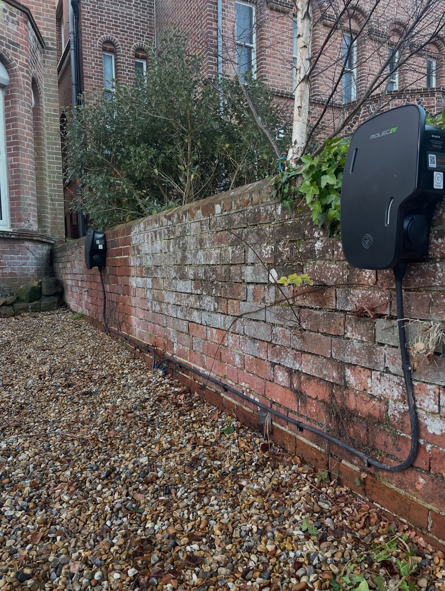 Rolec EV charge point on a garden wall with neatly clipped cable run